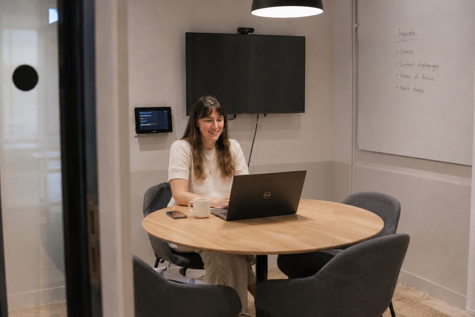 Eleonora in a meeting room preparing a conversation agenda